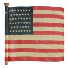 46 STAR U.S. MILITARY CAMP COLORS, PRESS-DYED ON WOOL BUNTING, MADE BY HORSTMANN, PHILADELPHIA, SIGNED AND DATED 1909, ON ITS REMARKABLE, ORIGINAL STAFF