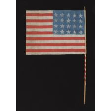 WWII PERIOD HOMEMADE PARADE FLAG WITH 20 STARS, 15 STRIPES THAT START AND END ON WHITE, AND A CANDY CANE STRIPED STAFF, MADE TO WELCOME U.S. SOLDIERS AFTER LIBERATION FROM GERMAN OCCUPATION, FOUND IN CHARTRES, FRANCE, ca 1944