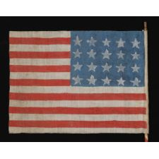 WWII PERIOD HOMEMADE PARADE FLAG WITH 20 STARS, 15 STRIPES THAT START AND END ON WHITE, AND A CANDY CANE STRIPED STAFF, MADE TO WELCOME U.S. SOLDIERS AFTER LIBERATION FROM GERMAN OCCUPATION, FOUND IN CHARTRES, FRANCE, ca 1944