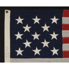 13 STARS ARRANGED IN A 3-2-3-2-3 PATTERN ON A SMALL-SCALE FLAG OF THE 1890's-1920's ERA WITH AN ELONGATED PROFILE, SIGNED "FLACK"