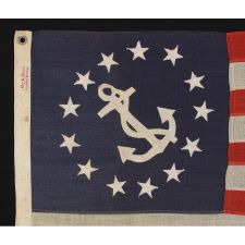 13 STAR PRIVATE YACHT ENSIGN WITH A "STAR BRAND" MAKER'S LABEL, AN ELONGATED FORMAT, A PLEASANTLY SHAPED ANCHOR AND A NICE SHAD OF INDIGO BLUE, 1910-1920's ERA