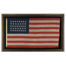 38 STAR FLAG WITH HAND-SEWN STARS, IN AN UNUSUALLY CONFINED PATTERN OF JUSTIFIED ROWS, ON AN ANTIQUE FLAG IN A SMALL SCALE FOR THE PERIOD, 1876-1889, COLORADO STATEHOOD