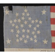 38 STAR FLAG WITH A RARE AND BEAUTIFUL VARIATION OF THE "GREAT STAR" OR "GREAT LUMINARY" PATTERN, AN EXAMPLE OF EXTRAORDINARY QUALITY, MADE BY R.W. MUSGROVE IN BRISTOL, NEW HAMPSHIRE FOR AN 1885 REUNION OF THE 12th NH VOLUNTEERS