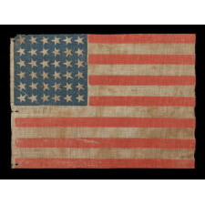 36 STAR ANTIQUE AMERICAN PARADE FLAG OF THE CIVIL WAR ERA, AN ATTRACTIVE EXAMPLE WITH ENDEARING WEAR, NICE COLORS, AND CANTED STARS, 1864-67, NEVADA STATEHOOD