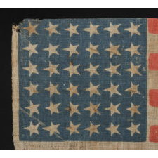 36 STAR ANTIQUE AMERICAN PARADE FLAG OF THE CIVIL WAR ERA, AN ATTRACTIVE EXAMPLE WITH ENDEARING WEAR, NICE COLORS, AND CANTED STARS, 1864-67, NEVADA STATEHOOD