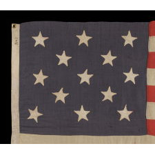 13 STARS ARRANGED IN A 3-2-3-2-3 PATTERN ON A BEAUTIFUL DUSTY BLUE CANTON, ON A SMALL-SCALE ANTIQUE AMERICAN FLAG MADE BETWEEN THE MID-1880'S AND 1890'S