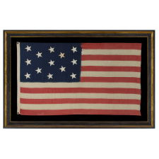 13 CANTED, HAND-SEWN STARS IN A 3-2-3-2-3 PATTERN, ON AN ANTIQUE AMERICAN FLAG MADE IN THE ERA OF THE 1876 CENTENNIAL OF AMERICAN INDEPENDENCE