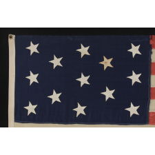 13 CANTED, HAND-SEWN STARS IN A 3-2-3-2-3 PATTERN, ON AN ANTIQUE AMERICAN FLAG MADE IN THE ERA OF THE 1876 CENTENNIAL OF AMERICAN INDEPENDENCE