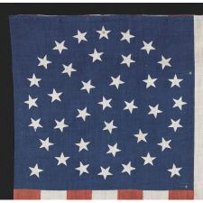 38 STARS IN A MEDALLION CONFIGURATION WITH 2 OUTLIERS, A RARE EXAMPLE OF THIS PATTERN ON A LARGE SCALE PARADE FLAG WITH RED STRIPES, 1876-1889, COLORADO STATEHOOD