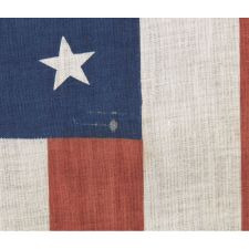 38 STARS IN A MEDALLION CONFIGURATION WITH 2 OUTLIERS, A RARE EXAMPLE OF THIS PATTERN ON A LARGE SCALE PARADE FLAG WITH RED STRIPES, 1876-1889, COLORADO STATEHOOD