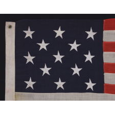 13 STARS ARRANGED IN A 3-2-3-2-3 PATTERN ON A SMALL-SCALE ANTIQUE AMERICAN FLAG MADE IN THE PERIOD BETWEEN THE LAST DECADE OF THE 19TH CENTURY AND THE FIRST QUARTER OF THE 20TH