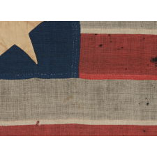 13 LARGE AND STRIKINGLY VISUAL STARS ON A U.S. NAVY SMALL BOAT ENSIGN, ENTIRELY HAND-SEWN, CA 1884-87