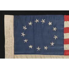 13 HAND-EMBROIDERED STARS AND EXPERTLY HAND-SEWN STRIPES, ON A FLAG MADE BY RACHEL ALBRIGHT, GRANDDAUGHTER OF BETSY ROSS, IN PHILADELPHIA IN 1903, A VERY LARGE EXAMPLE AMONG ITS COUNTERPARTS, WITH A STAR CONFIGURATION THAT IS MORE OVAL THAN CIRCULAR