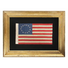 13 HAND-EMBROIDERED STARS AND EXPERTLY HAND-SEWN STRIPES, ON A FLAG MADE BY RACHEL ALBRIGHT, GRANDDAUGHTER OF BETSY ROSS, IN PHILADELPHIA IN 1903, A VERY LARGE EXAMPLE AMONG ITS COUNTERPARTS, WITH A STAR CONFIGURATION THAT IS MORE OVAL THAN CIRCULAR