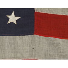 38 HAND-SEWN STARS STITCHED WITH BROWN THREAD TO A STEEL BLUE CANTON, AN ANTIQUE MERICAN FLAG WITH EXCEPTIONAL CONDITION, COLORADO STATEHOOD, 1876-1889