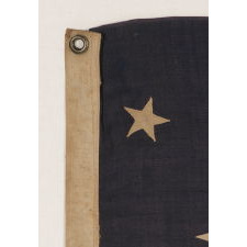 13 STARS IN A MEDALLION CONFIGURATION ON A SMALL-SCALE ANTIQUE AMERICAN FLAG OF THE 1890-1900 ERA, WITH AMPLE WEAR AND LOSSES