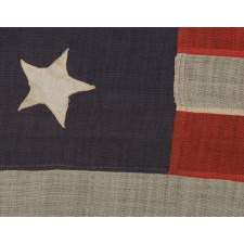 13 STARS IN A 4-5-4 PATTERN ON STONE BLUE CANTON, ON A FLAG WITH BEAUTIFUL ELONGATED PROPORTIONS, MADE BETWEEN 1876 AND THE EARLY 1890’s