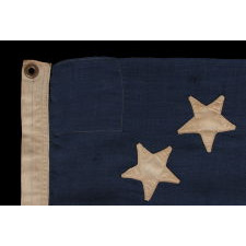 13 STARS IN A CIRCULAR VERSION OF THE 3RD MARYLAND PATTERN, ON A SMALL SCALE FLAG PROBABLY DATING TO THE FIRST HALF OF THE 1890'S, WITH ENDEARING PRESENTATION FROM EXTENDED USE