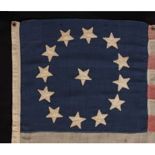 13 STARS IN A CIRCULAR VERSION OF THE 3RD MARYLAND PATTERN, ON A SMALL SCALE FLAG PROBABLY DATING TO THE FIRST HALF OF THE 1890'S, WITH ENDEARING PRESENTATION FROM EXTENDED USE