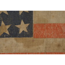 25 STARS IN A VERY RARE LINEAL ARRANGEMENT THAT FEATURES A LARGE CENTER STAR, SOUTHERN-EXCLUSIONARY, THE ONLY KNOWN EXAMPLE IN THIS STYLE AND THE ONLY 19TH CENTURY PARADE FLAG IN THIS STAR COUNT