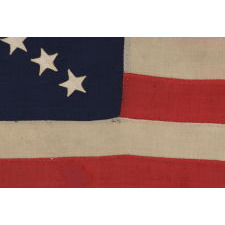 38 STARS ON AN ENTIRELY HAND-SEWN FLAG WITH A DYNAMIC STARBURST CROSS, ONE OF THE MOST RARE & VISUALLY SPECTACULAR CONFIGURATIONS IN FLAG COLLECTING; ONCE BELONGING TO IRA SWARTZ OF PENNSYLVANIA, A CAREER SOLDIER WHO SERVED WITH THE FAMED 1ST MICHIGAN CAVALRY DURING THE CIVIL WAR; MADE CA 1876-1889