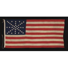 38 STARS ON AN ENTIRELY HAND-SEWN FLAG WITH A DYNAMIC STARBURST CROSS, ONE OF THE MOST RARE & VISUALLY SPECTACULAR CONFIGURATIONS IN FLAG COLLECTING; ONCE BELONGING TO IRA SWARTZ OF PENNSYLVANIA, A CAREER SOLDIER WHO SERVED WITH THE FAMED 1ST MICHIGAN CAVALRY DURING THE CIVIL WAR; MADE CA 1876-1889