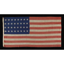 32 STAR ANTIQUE AMERICAN FLAG, REPRESENTING MINNESOTA STATEHOOD, 1858-59, IN A STYLE KNOWN TO HAVE SEEN MILITARY SERVICE DURING THE FORTHCOMING CIVIL WAR (1861-65) AND BEARING THE SIGNATURE OF A SOLDIER WHO FOUGHT WITH THE 15TH MICHIGAN INFANTRY, POSSIBLY MADE BY THE ANNIN COMPANY IN NEW YORK CITY