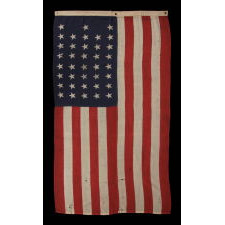 38 STARS IN A "NOTCHED" PATTERN ON A CLAMP-DYED AMERICAN FLAG OF THE 1876-1889 PERIOD, REFLECTS COLORADO STATEHOOD, MADE BY THE U.S. BUNTING COMPANY IN LOWELL, MASSACHUSETTS​