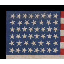 46 STARS ON A BRILLIANT ROYAL BLUE CANTON, ON AN ANTIQUE AMERICAN FLAG OF THE 1907-1912 PERIOD, OKLAHOMA STATEHOOD, SCATTERED STAR POSITIONING