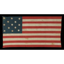 13 HAND-SEWN STARS ARRANGED IN A 3-2-3-2-3 PATTERN, WITH VARYING VERTICAL ORIENTATION, ON A HOMEMADE ANTIQUE AMERICAN FLAG DATING TO THE ERA OF THE 1876 CENTENNIAL OF AMERICAN INDEPENDENCE