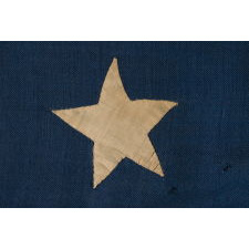 13 HAND-SEWN STARS IN A 3-2-3-2-3 CONFIGURATION OF LINEAL ROWS, ON A LARGE SCALE ANTIQUE AMERICAN FLAG WITH A STENCILED SIGNATURE ALONG THE HOIST THAT READS "GEO L. WRIGHT. BOYLSTON. MA.", PROBABLY MADE FOR THE 100-YEAR ANNIVERSARY OF AMERICAN INDEPENDENCE IN 1876