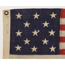 13 STARS ARRANGED IN A 3-2-3-2-3 LINEAL CONFIGURATION ON AN TINY ANTIQUE AMERICAN FLAG AMONG ITS COUNTERPARTS WITH PIECED-AND-SEWN CONSTRUCTION, ca 1895-1920's, MADE BY THE ANNIN COMPANY OF NEW YORK & NEW JERSEY