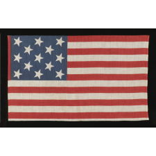 13 STAR PARADE FLAG IN A 3-2-3-2-3 PATTERN, MADE CA 1876-1898, UNUSUALLY LARGE AND WITH AN UNUSUAL STAR PATTERN AMONG ITS COUNTERPARTS OF THE 19TH CENTURY
