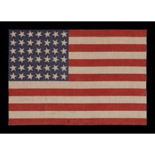 42 STARS, AN UNOFFICIAL STAR COUNT, ON AN ANTIQUE AMERICAN FLAG WITH SCATTERED STAR POSITIONING, SIGNED "MRS. G.M. GILLETTE," 1889-1890, WASHINGTON STATEHOOD