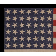 42 STARS, AN UNOFFICIAL STAR COUNT, ON AN ANTIQUE AMERICAN FLAG WITH SCATTERED STAR POSITIONING, SIGNED "MRS. G.M. GILLETTE," 1889-1890, WASHINGTON STATEHOOD