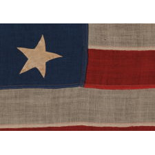 13 HAND-SEWN STARS IN A 3-2-3-2-3 PATTERN ON AN ANTIQUE AMERICAN FLAG OF THE 1876 CENTENNIAL ERA, POSSIBLY A U.S. NAVY SMALL BOAT ENSIGN