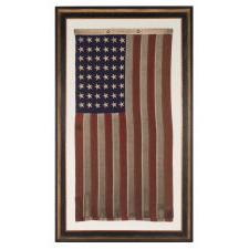 48 STAR, U.S. NAVY SMALL BOAT ENSIGN, MADE AT MARE ISLAND, CALIFORNIA [HEADQUARTERS OF THE PACIFIC FLEET] DURING WWII, SIGNED AND DATED JULY 1942, WITH EXTENSIVE WEAR FROM OBVIOUS USE