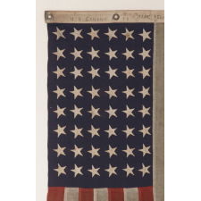 48 STAR, U.S. NAVY SMALL BOAT ENSIGN, MADE AT MARE ISLAND, CALIFORNIA [HEADQUARTERS OF THE PACIFIC FLEET] DURING WWII, SIGNED AND DATED JULY 1942, WITH EXTENSIVE WEAR FROM OBVIOUS USE