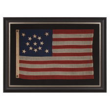 13 STARS IN A MEDALLION CONFIGURATION ON A SMALL-SCALE ANTIQUE AMERICAN FLAG OF THE 1895-1926 ERA, SIGNED "TAUTOG," PROBABLY FLOWN ON THE YACHT OF THAT NAME BY OWNER GEORGE GARDINER FRY, WHO WON MANY RACES WITH HER AT THE TURN-OF-THE-CENTURY