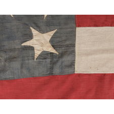 33 STAR ANTIQUE AMERICAN FLAG WITH 11 STRIPES, HAPHAZARD STAR PLACEMENT, AND ITS CANTON RESTING ON THE WAR STRIPE; MADE IN THE PERIOD BETWEEN 1859-1861, OREGON STATEHOOD, PRE-CIVIL WAR THROUGH THE WAR'S OPENING YEAR