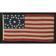 34 STARS, IN A CONFIGURATION THAT IS UNIQUE TO THIS SMALL SCALE, CIVIL WAR FLAG, WITH SUBSTANTIAL FOLK ART QUALITIES, 1861-63, KANSAS STATEHOOD