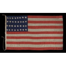 32 STARS ON AN ANTIQUE AMERICAN FLAG WITH ITS CANTON RESTING ON THE WAR STRIPE, MADE IN THE PERIOD WHEN MINNESOTA JOINED THE UNION AS THE 32nd STATE; A VERY RARE STAR COUNT, OFFICIAL FOR JUST ONE YEAR, AND ACCURATE FOR JUST NINE MONTHS, 1858-59