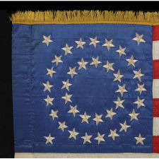 RARE & BEAUTIFUL 38 STAR ANTIQUE AMERICAN FLAG, AN INDIAN WAR PERIOD MILITARY GUIDON, MADE OF SILK AND ENTIRELY HAND-SEWN, WITH EMBROIDERED STARS IN A MEDALLION CONFIGURATION, 1876-1889, COLORADO STATEHOOD