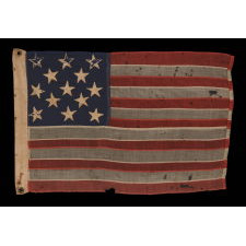 13 HAND-SEWN STARS IN A 3-2-3-2-3 PATTERN ON AN ANTIQUE AMERICAN FLAG WITH ENDEARING WEAR FROM LONG-TERM USE, PROBABLY MADE DURING THE AMERICAN CIVIL WAR (1861-65), AND POSSIBLY ONCE BELONGING TO CIVIL WAR GENERAL AND SECRETARY OF THE NAVY BENJAMIN FRANKLIN TRACY