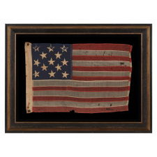 13 HAND-SEWN STARS IN A 3-2-3-2-3 PATTERN ON AN ANTIQUE AMERICAN FLAG WITH ENDEARING WEAR FROM LONG-TERM USE, PROBABLY MADE DURING THE AMERICAN CIVIL WAR (1861-65), AND POSSIBLY ONCE BELONGING TO CIVIL WAR GENERAL AND SECRETARY OF THE NAVY BENJAMIN FRANKLIN TRACY