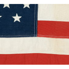 49 EMBROIDERED STARS ON A SMALL SCALE PIECED-AND-SEWN AMERICAN FLAG REFLECTING THE ADDITION OF ALASKA IN 1959, OFFICIAL FOR JUST ONE YEAR, MADE BY THE ANNIN COMPANY OF NEW YORK & NEW JERSEY