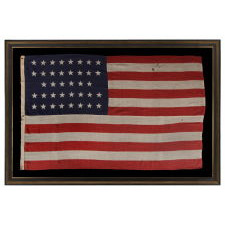 38 STARS IN A "NOTCHED" PATTERN ON A 7 ft. CLAMP-DYED AMERICAN FLAG OF THE 1876-1889 PERIOD, REFLECTS COLORADO STATEHOOD, MADE BY THE U.S. BUNTING COMPANY IN LOWELL, MASSACHUSETTS