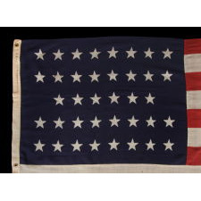38 STARS IN A "NOTCHED" PATTERN ON A 7 ft. CLAMP-DYED AMERICAN FLAG OF THE 1876-1889 PERIOD, REFLECTS COLORADO STATEHOOD, MADE BY THE U.S. BUNTING COMPANY IN LOWELL, MASSACHUSETTS