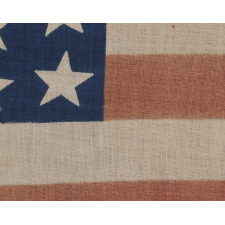 39 STARS IN TWO SIZES, ALTERNATING FROM ONE COLUMN TO THE NEXT, ON AN ANTIQUE AMERICAN PARADE FLAG DATING TO THE 1876 CENTENNIAL, NEVER AN OFFICIAL STAR COUNT, REFLECTS THE ANTICIPATED ARRIVAL OF THE DAKOTA TERRITORY