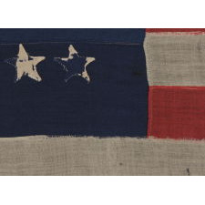 38 STAR FLAG WITH HAND-SEWN STARS IN A CONFINED PATTERN OF JUSTIFIED ROWS, ENDEARING WEAR, AND WONDERFUL PRESENTATION, 1876-1889, COLORADO STATEHOOD